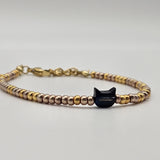 Bracciale in perline dorate e gattino blu